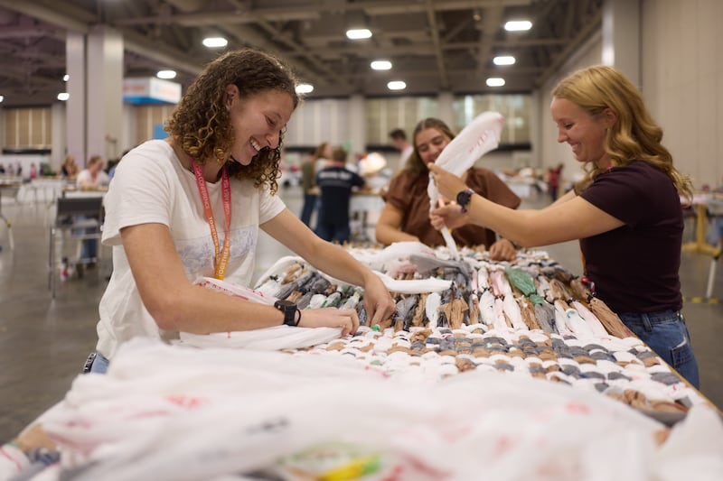 Several attendees participate in a service project at the 2026 Utah Area YSA Conference at the Salt Palace Convention Center in Salt Lake City on Friday, Aug. 14, 2026.