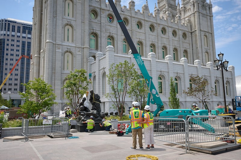 Crews install the Jesus Christ With the Woman at the Well statue at Temple Square in Salt Lake City on Wednesday, July 15, 2026.