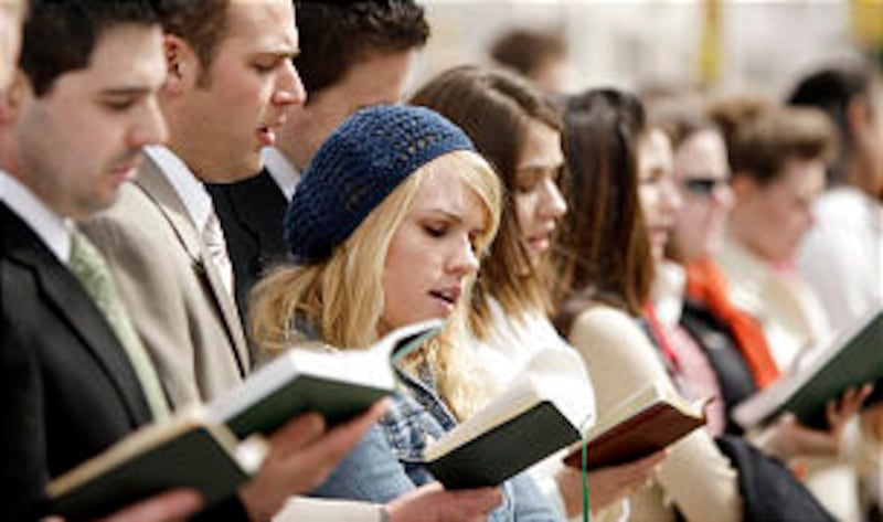 LDS Business College students sing a hymn for passing pedestrians to enjoy along a sidewalk outside