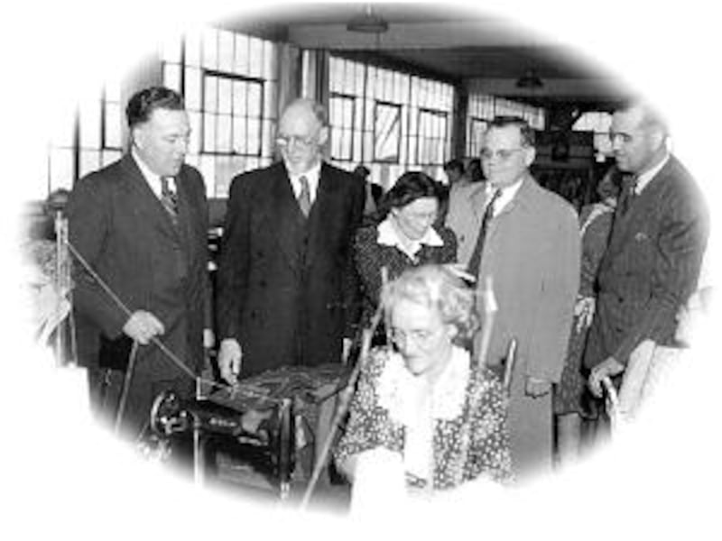 Elder Harold B. Lee, then of Quorum of the Twelve, at left, explains 1946 welfare sewing project to
