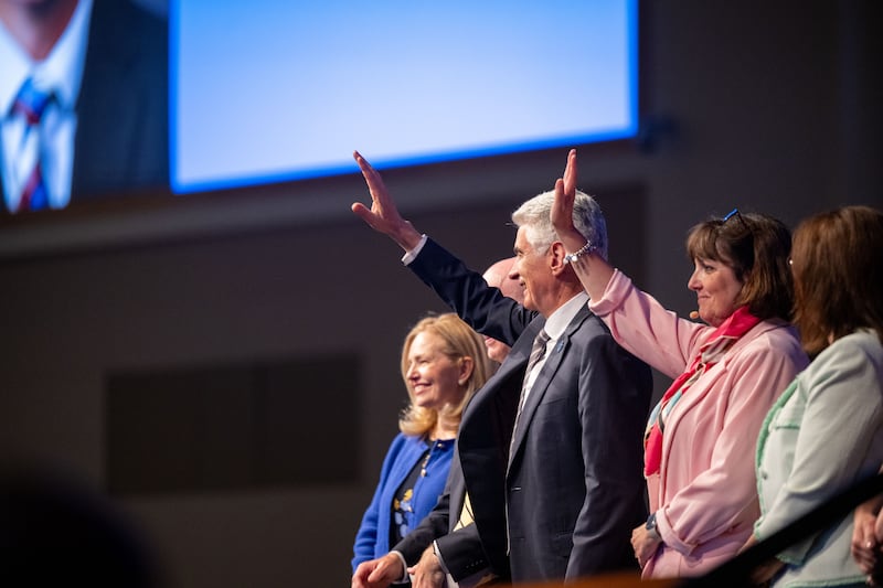 Elder Gérald Caussé of the Quorum of the Twelve Apostles and his wife, Sister Valérie Caussé, wave to students during a BYU–Idaho devotional in Rexburg, Idaho, on Sunday, June 14, 2026.