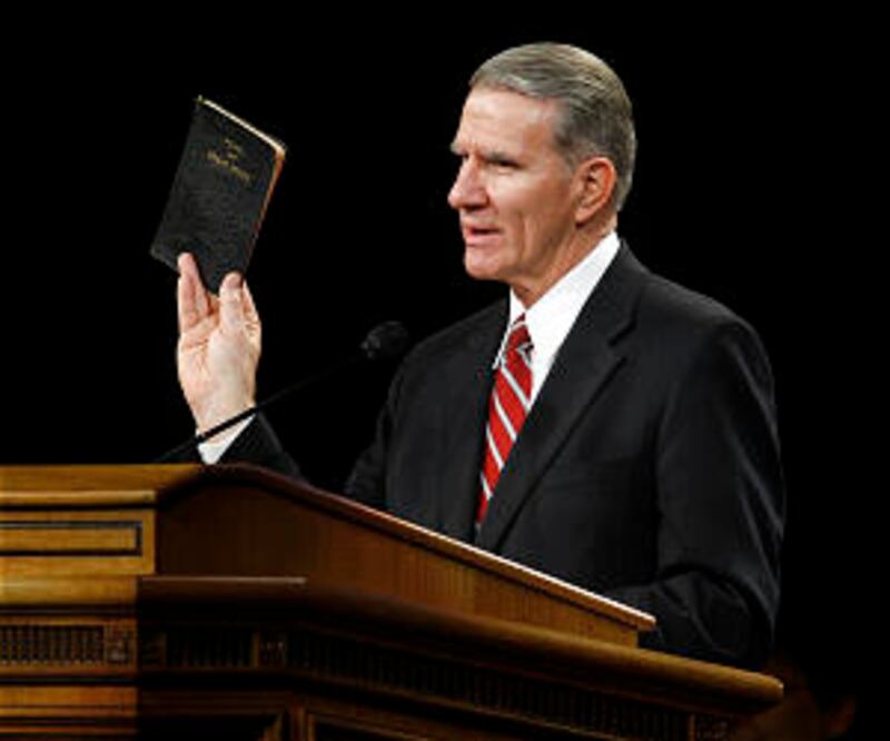 Elder Jay E. Jensen holds up his copy of the Pearl of Great Price, a book he said greatly helped to
