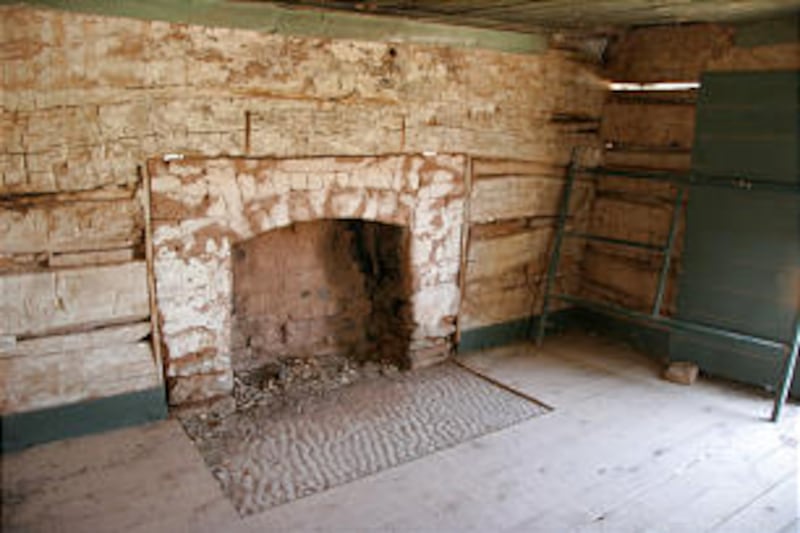 The original adobe fireplace still stands in the Louisa Foster Russell Home, a gabled wood structure