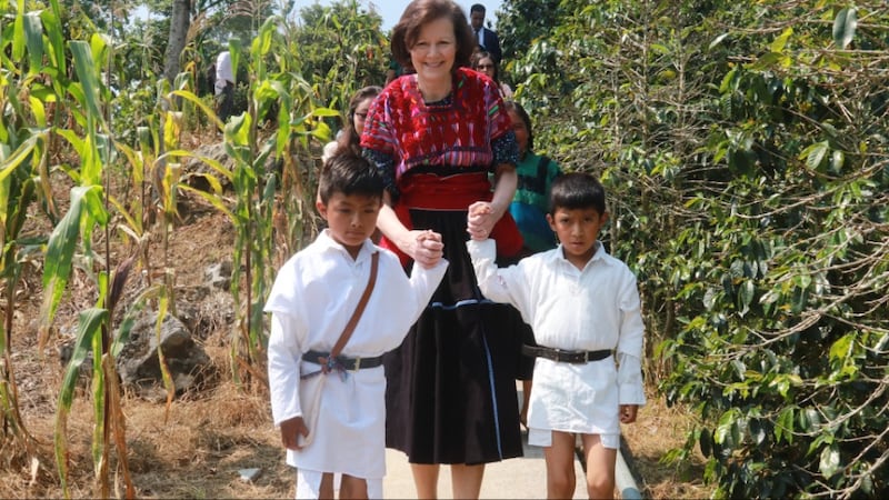 President Susan H. Porter is led by two boys through a corn field in Chenalhó, Chiapas, Mexico, in May 2026.