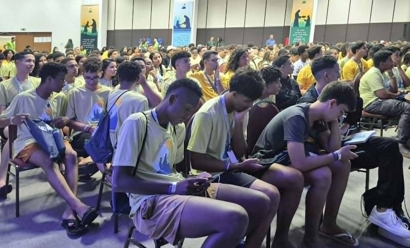 Young people read scripture on their mobile phones during an FSY session in Rio de Janeiro, Brazil, February 2026.