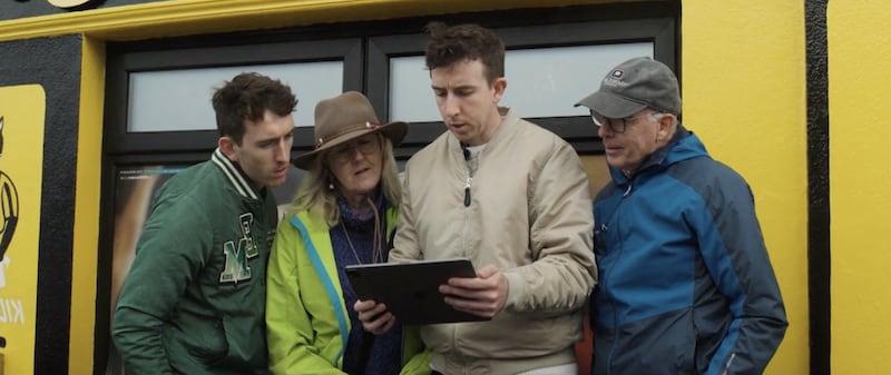 Matthew and Michael Gardiner with their parents reading about their third great-grandfather in front of the pub he owned during their RootsTech virtual keynote address in February 2026.