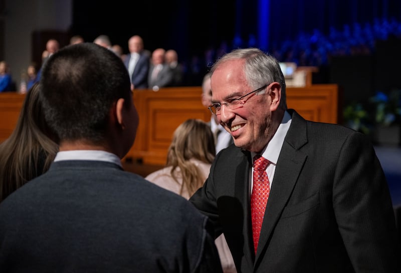 Elder Neil L. Andersen of the Quorum of the Twelve Apostles shakes hands with students gathered in the BYU–I Center during a devotional on Sunday, Feb. 22, 2026, in Rexburg, Idaho.
