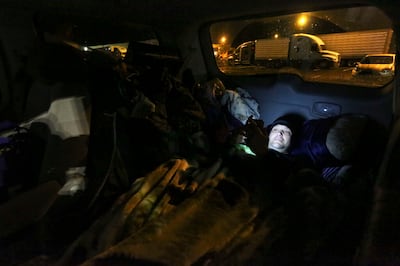 Jesse Kinman looks at his phone before going to sleep in his van, outside of Walmart in Puyallup, Wash., on Sunday, Jan. 26, 2020. Kinman has been homeless for most of his adult life. He struggled with alcohol and a meth addiction for more than 18 years, but is now clean and sober.