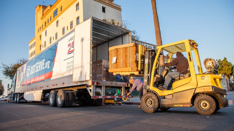 A fork lift is used to help unload a truck full of food donated by The Church of Jesus Christ of Latter-day Saints for several missions in Los Angeles, California, on Thursday, Jan. 29, 2026.