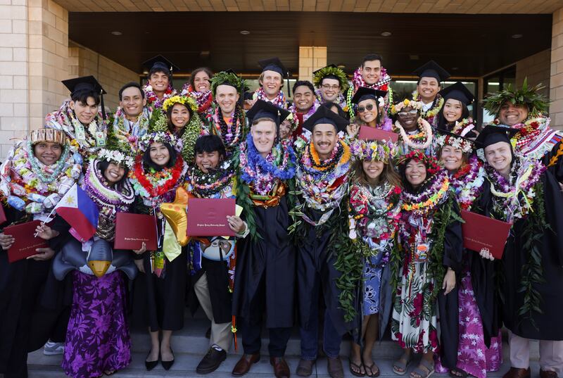 BYU–Hawaii graduates celebrate with friends and family outside the Cannon Activities Center in Laie, Hawaii, following commencement on Friday, Dec. 12, 2025.