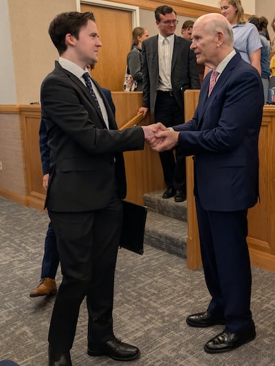 Elder Dale G. Renlund of the Quorum of the Twelve Apostles greets young adults following a devotional at the Jordan Institute of Religion in West Jordan, Utah, on Sunday, April 19, 2026.