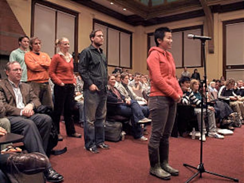 Students line up to ask Elder Oaks questions.