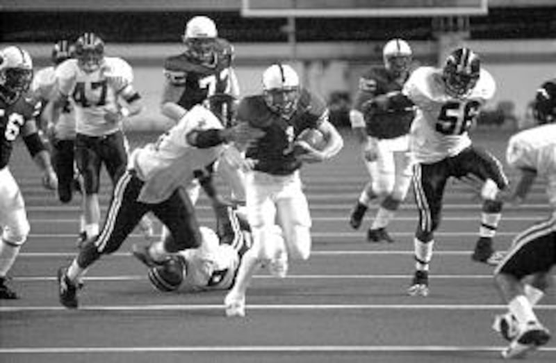 Travis Christensen of Ricks College runs through a Lackawanna College defender in Real Dairy Bowl. R
