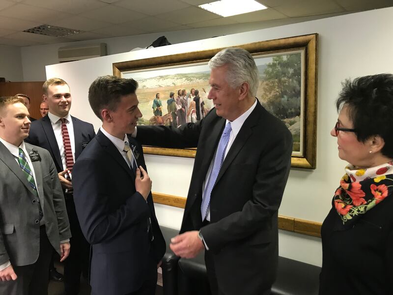 Elder Dieter F. Uchtdorf of the Quorum o the Twelve Apostles, center, and his wife, Sister Harriet Uchtdorf, right, greet volunteers from the Russia Moscow Mission on April 24, 2018.