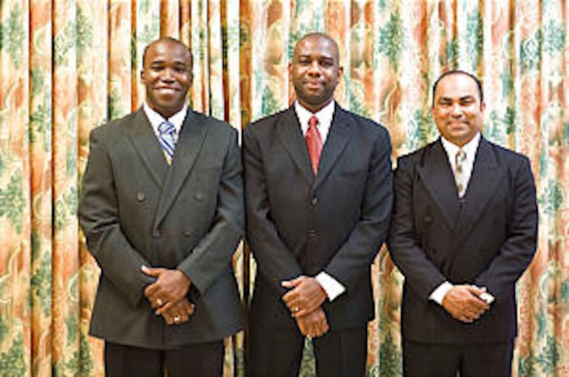 Port of Spain Stake president Emrol Gould, center, stands with his counselors, President Christopher
