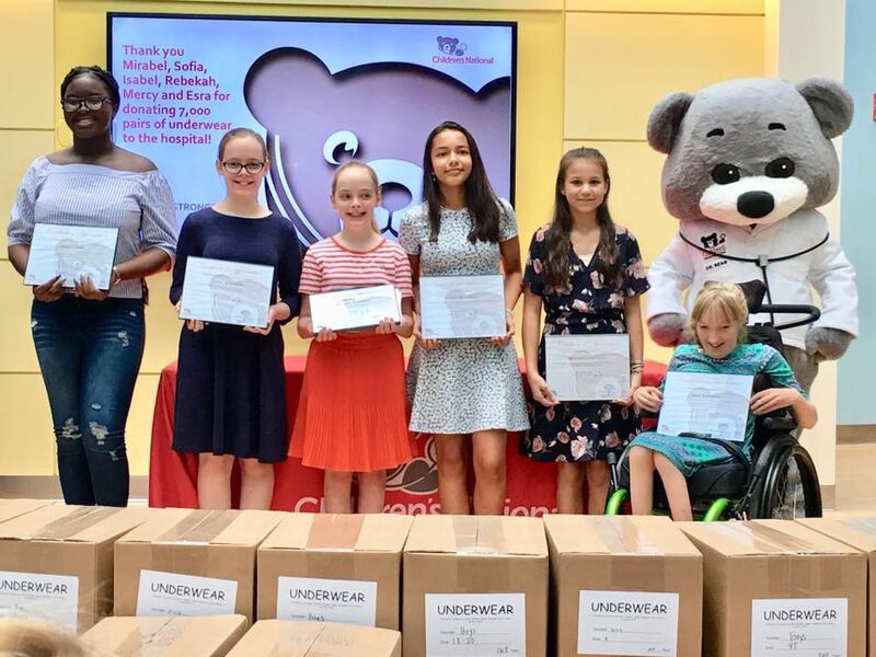 From left: Mercy Agwu, Mirabel Atkinson, Sofia Atkinson, Isabel Marchena, Rebekah Lahti, and Esra Edwards; young women from the Capitol Hill and Anacostia wards in Washington, D.C., at the Children’s National Medical Center after they collected and donated more than 7,000 pairs of underwear.