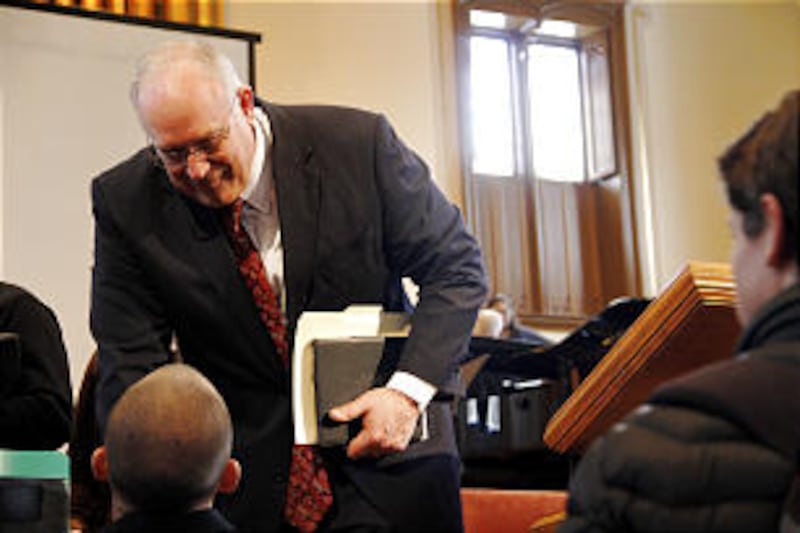 Elder Paul V. Johnson stops to shake hands with an LDS Business College student following a devotion