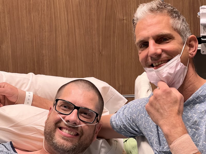 Brad Bywater and Chris Runkel smile moments after the two underwent kidney transplant surgery on Sept. 26, 2023, in the Mayo Clinic Hospital in Phoenix, Arizona.