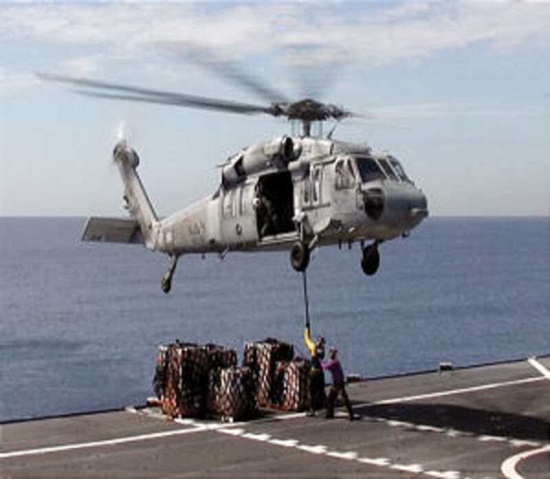 Church-donated supplies are delivered by helicopter to a medical supply ship as part of "Operation C
