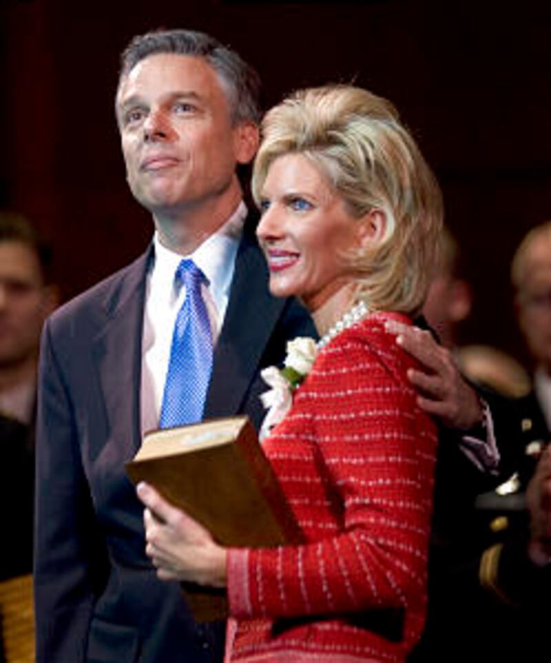 Governor Jon M. Huntsman, Jr. and his wife Mary Kay stand as the audience aplauds after he was sworn