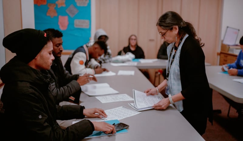 An instructor, right, teaches during an English as a Second Language class held at the Wembley Friendship and Outreach Center.