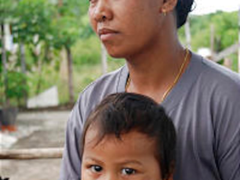 Church humanitarian projects in Indonesia following 2004 tsunami. Karlina holds her son, Saimuddin.