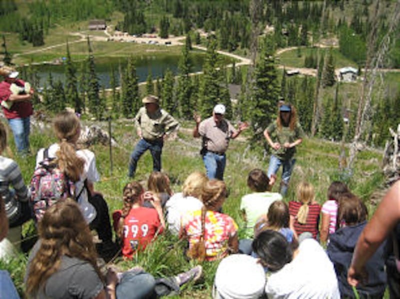 Elder Keith Zobell, a forester and service missionary for the Church, tells young women about the da