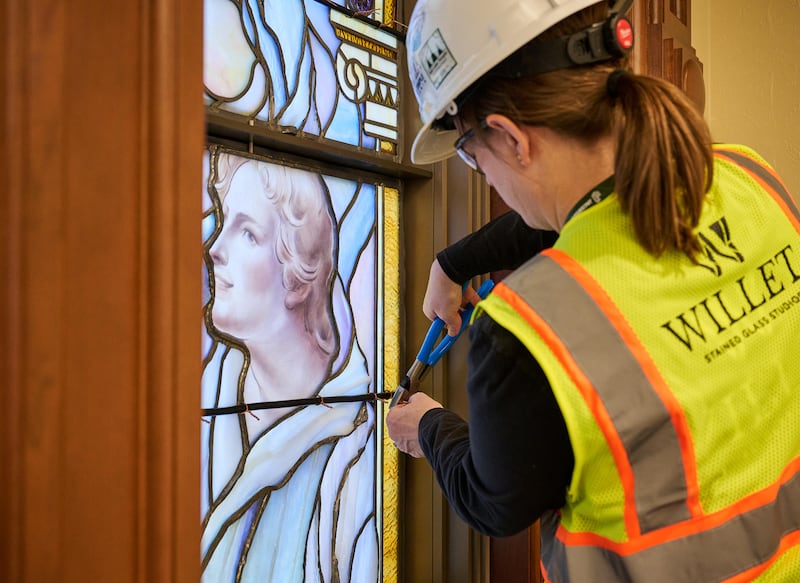 A crew member meticulously places panels of art glass in the north entrance buildings on Temple Square in Salt Lake City on Wednesday, March 11, 2026.