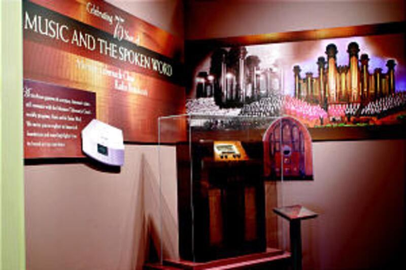 Combining photos of contemporary choir and that of 1929, opening display includes a radio from that