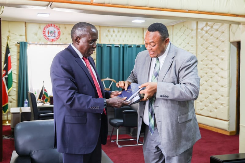 Elder Thierry K. Mutombo, General Authority Seventy and Africa Central Area president presents a Book of Mormon to Joseph Ole Lenku, Kajiado county Governor in Kaijado, Kenya, on July 30, 2025.