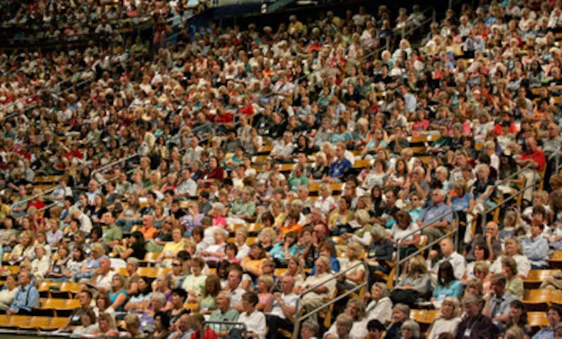 BYU Campus Education Week attendees listen as Elder Steven E. Snow speaks during a devotional in the