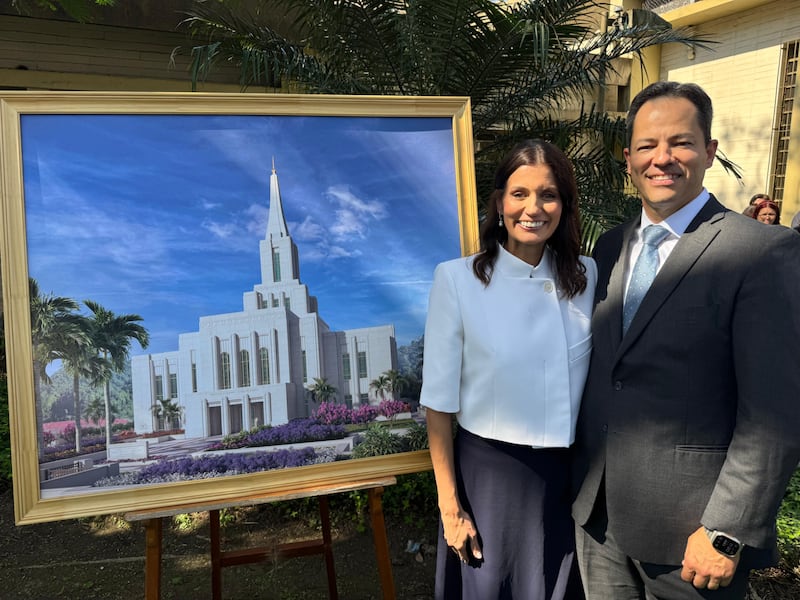 Elder Ronald M. Barcellos, a General Authority Seventy and counselor in the Brazil Area presidency, and his wife, Sister Karin Barcellos, stand near an architectural rendering of the Santos Brazil Temple at its groundbreaking ceremony on Saturday, Aug. 1, 2026, in Santos, Brazil.