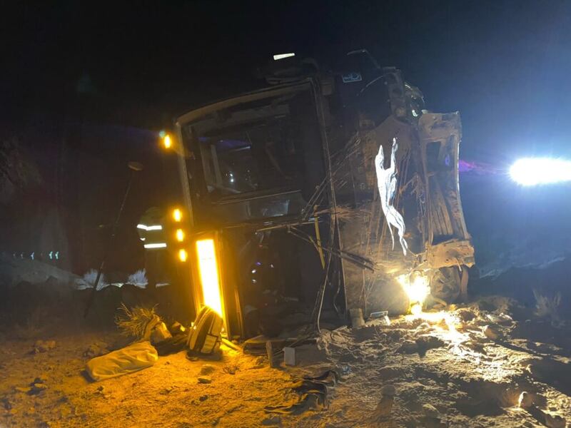 The lights of the emergency vehicles shine on the scene where a Greyhound bus overturned off I-70 in Emery County, Utah on Dec. 27, 2021.