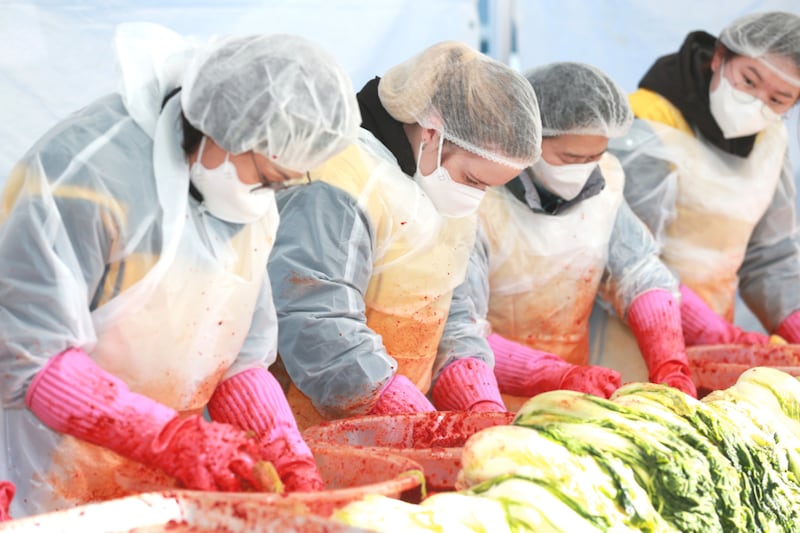Four people from the Changwon Korea Stake prepare kimchi during the "Sharing Kimchi with Love Festival" in Changwon, South Korea, on Dec. 12, 2025.