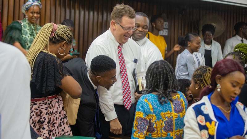 Elder Clark G. Gilbert greets students and visitors at a devotional in Lagos, Nigeria, Jan. 14, 2024.