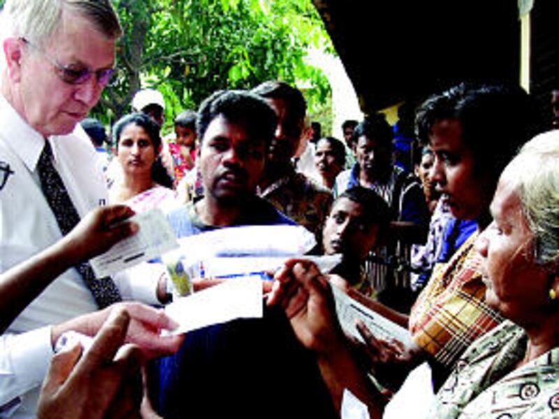 Bishop Richard C. Edgley, first counselor in the Presiding Bishopric, takes part in distribution of