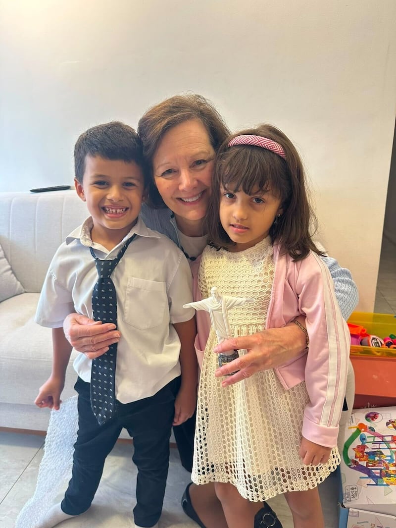 Primary General President Susan H. Porter, center, takes a picture with two children in Brazil, Saturday, June 13, 2026.