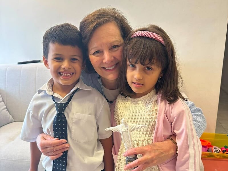 Primary General President Susan H. Porter, center, takes a picture with two children in Brazil, Saturday, June 13, 2026.