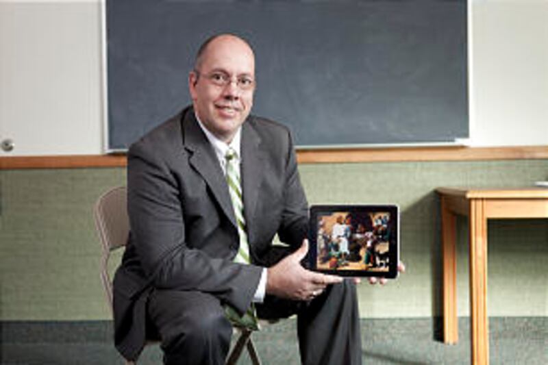 Ken Knapton, a Church technology employee, displays a picture of Jesus Christ from the gospel art ki