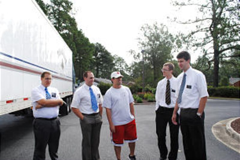 Missionaries and a member in the Kinston North Carolina Stake prepare to deliver 200 cleaning, flood