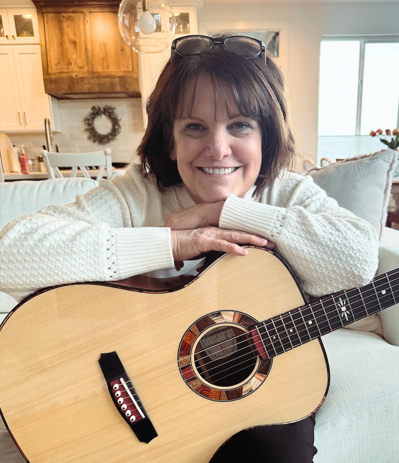 Shawna Edwards — composer of "The Miracle," a new addition to Hymns for Home and Church — poses for a photo with a guitar in Lehi, Utah, in January 2025.