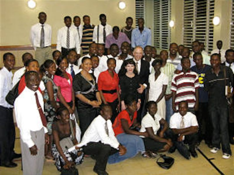 Elder Neil L. Andersen and his wife, Kathy Andersen, visit with young single adult members of the Mo