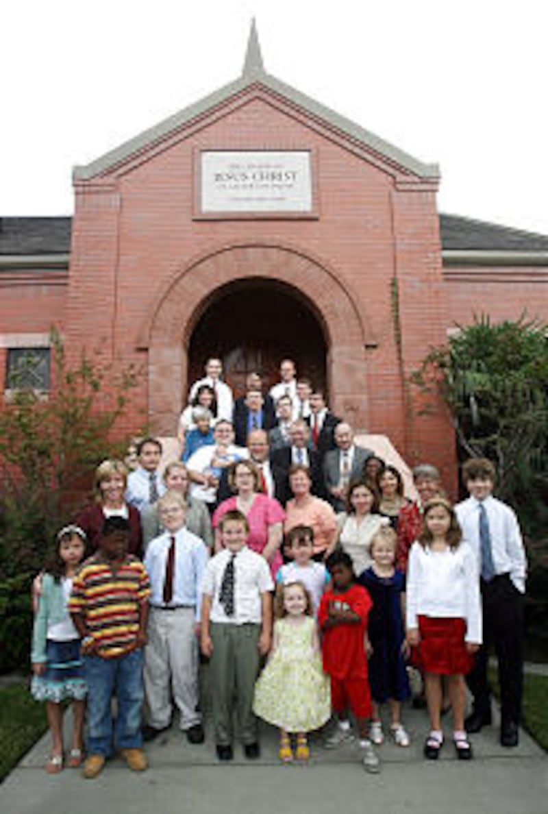 Members of the New Orleans 1st Branch are shown outside their small meetinghouse in July 2006. For t
