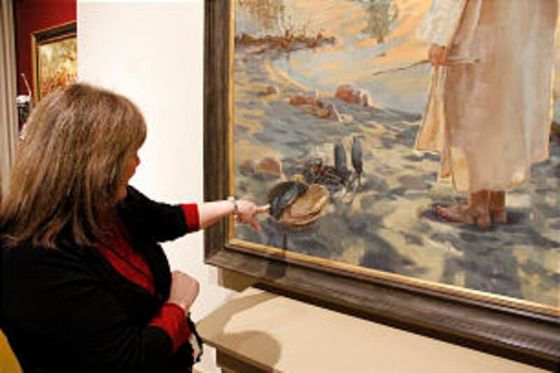 Rita R. Wright, curator of art and artifacts, points out detail in "Feed My Sheep" by David Andre Ko
