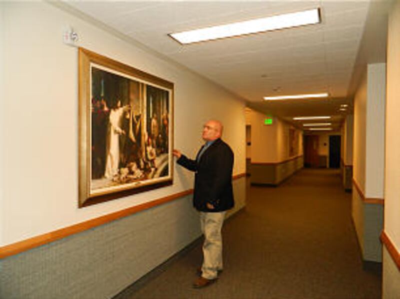 In the Joplin Missouri Stake Center, Bishop Dave Richins of the Joplin 2nd Ward admires a copy of a