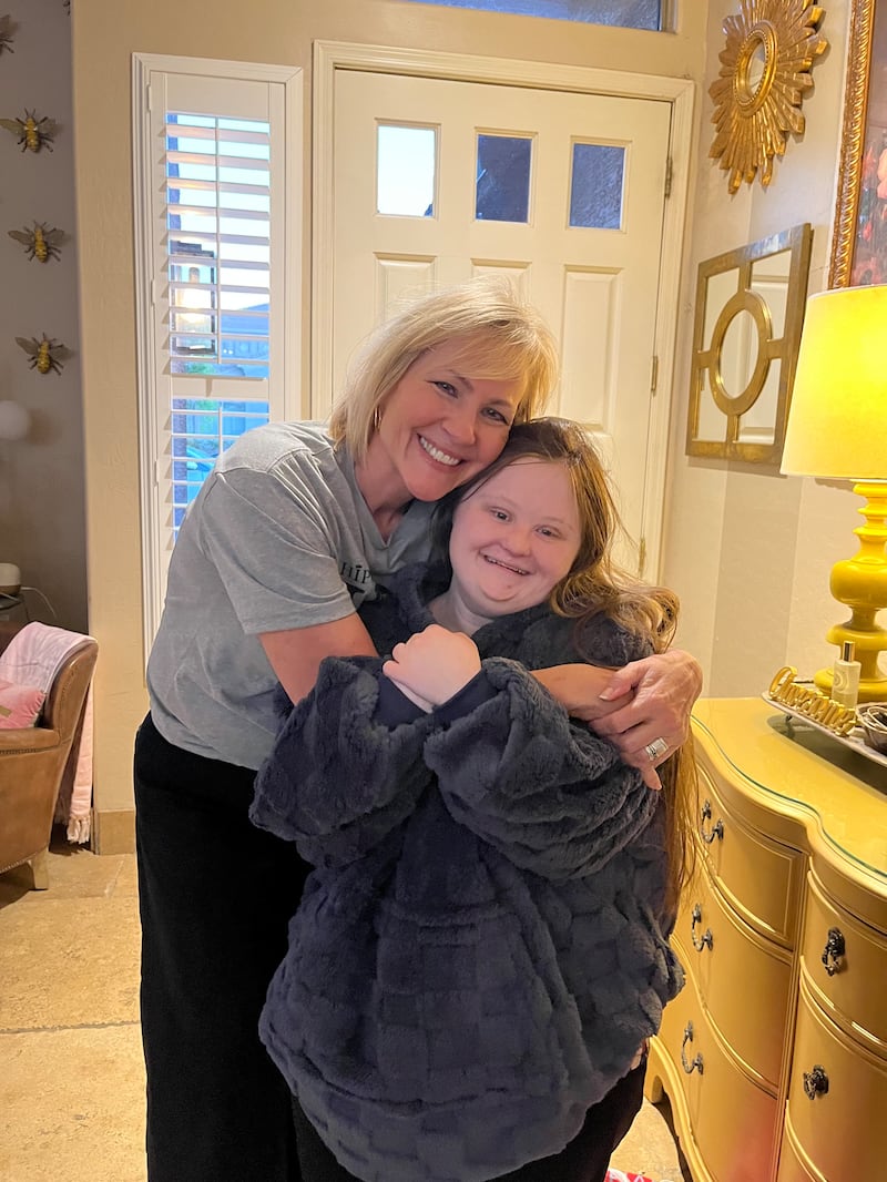 Carol Tingey, left, embraces Kennedy Swartz in a hug on July 30, 2025, in Gilbert, Arizona.