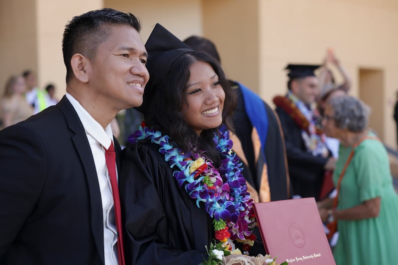 BYU–Hawaii graduates celebrate with family and friends outside the Cannon Activities Center in Laie, Hawaii, following commencement on Friday, Dec. 12, 2025.