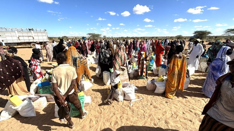 Groups of villagers stand by their piles of relief supplies and food given by the Church and National Muslim Leaders Forum in Korr, Kenya, May, 29, 2026.