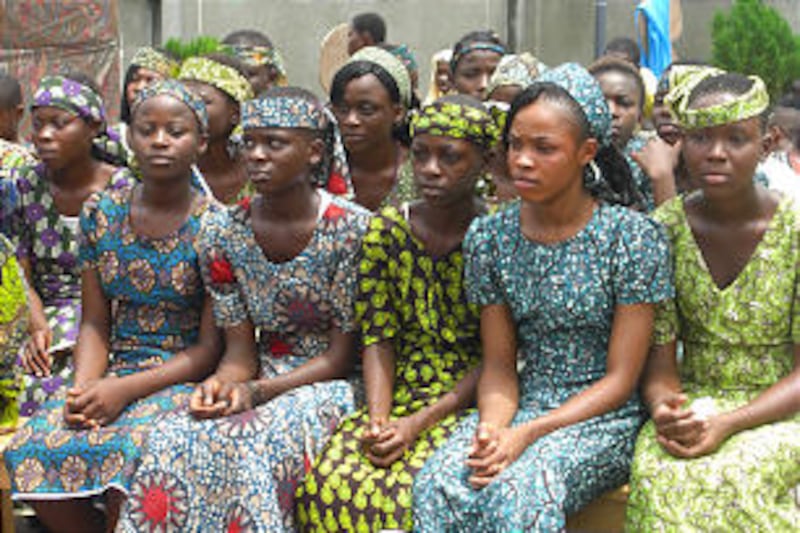 Young women from Aba, Nigeria, sit in costume as they play Nephite girls from the Book of Mormon.