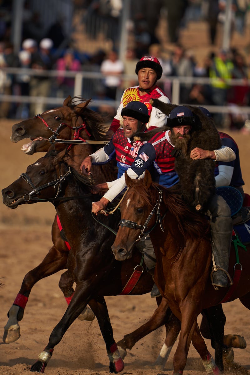 Team USA's Ladd Howell absorbs contact from another ride while holding the goat carcass over his shoulder during a game of Kok-Boru during the World Nomad Games, held Aug. 31 to Sept. 6 in Bishkek and Cholpon-Ata, Kyrgyzstan.